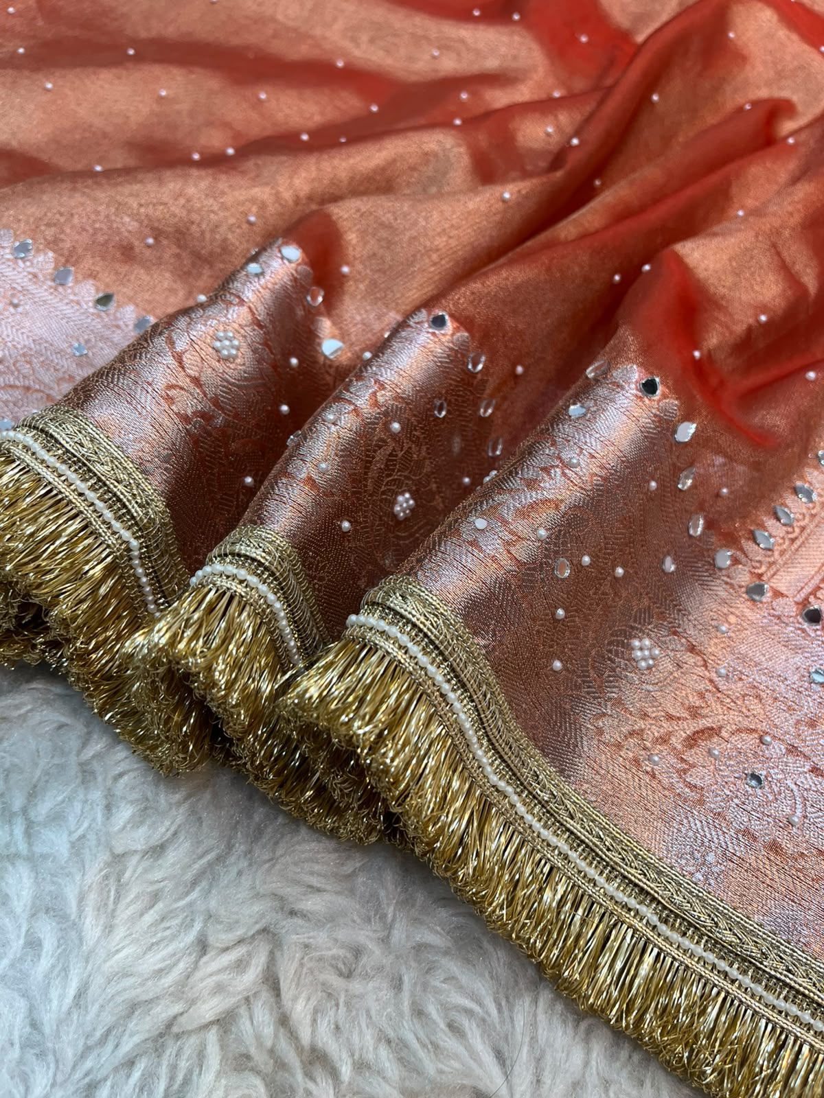 Tissue Silk Saree in Burnt Orange – Mirror & Stone Handwork with Traditional Fringe Lace Border